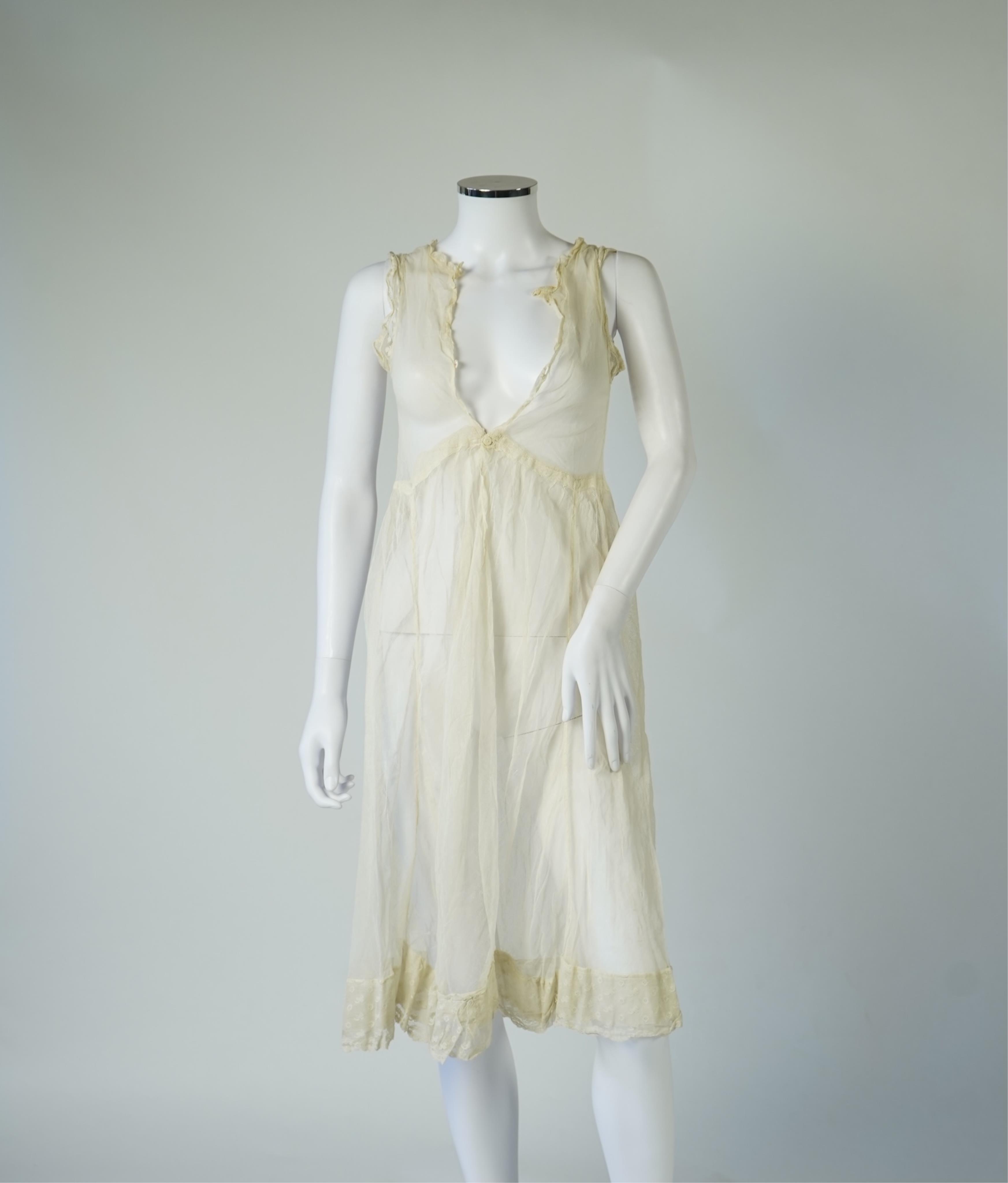 An early 20’s cream net ladies summer dress and net petticoat, designed with a lace inset front skirt, yolk and sleeves.103cm long. Condition - both need re-laundering and some seams tidying.